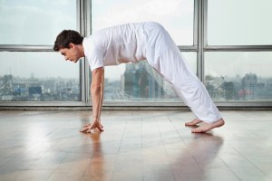 Man Practicing Yoga At Gym